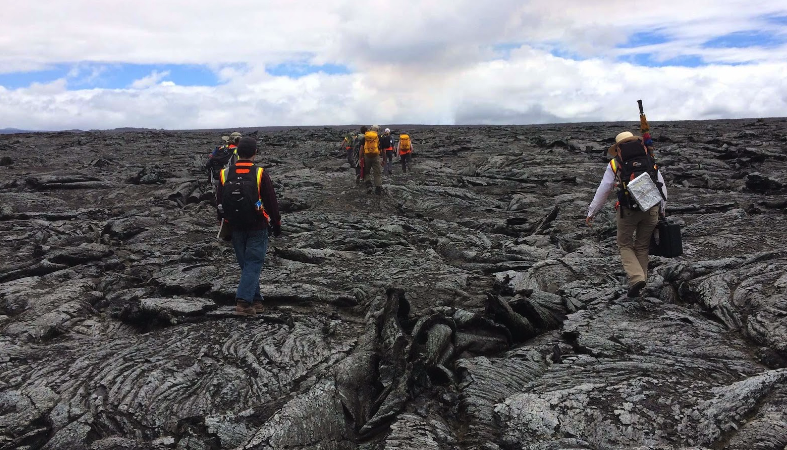 Hikers walking on slopes of Hawaii's Kilauea Volcano.